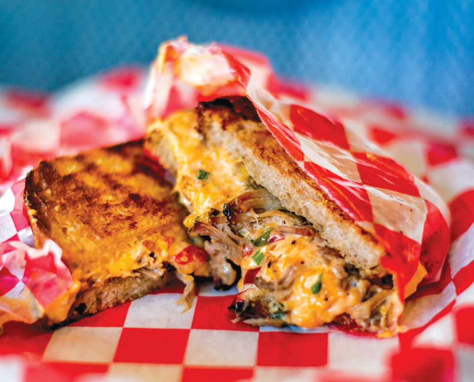 Mouth watering photo of grilled pimento cheese and pulled pork sandwich